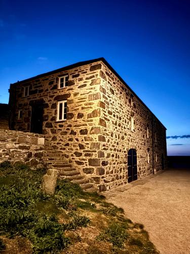 a stone building with a window on the side of it at Bright, Spacious 5-Bed, 4-Bathroom home on Loch Soy in Portsoy