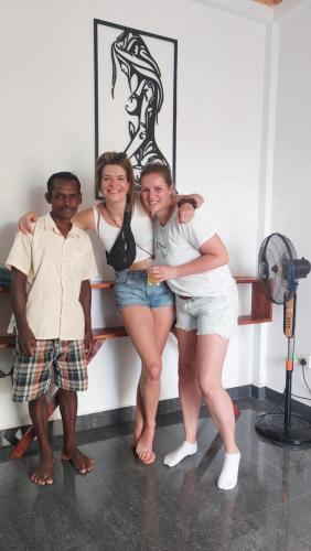 a group of three people posing for a picture at Coastal Heaven Villa in Trincomalee