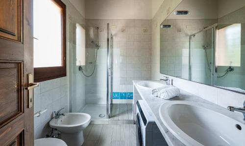 a bathroom with a sink and a tub and a toilet at Villa Fiori 3 in Is Molas 