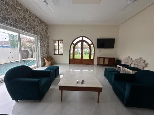 a living room with two blue couches and a table at The nature amer in Jaipur
