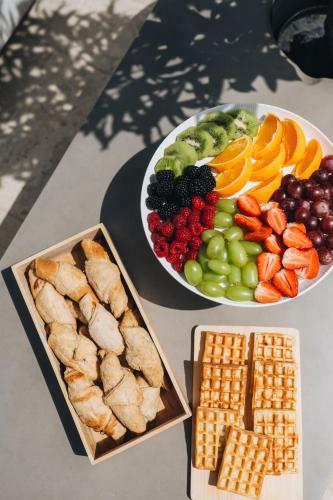 a table topped with two plates of food with fruit at NEW!!! La Magrina - Bed&Breakfast in Vrsar