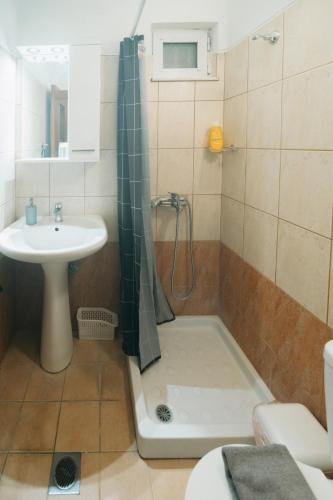 a bathroom with a shower and a sink and a tub at Iriana's Home in Kos