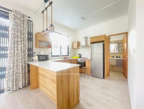 a kitchen with a large island in the middle at Residence Alice in Midlands Station