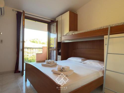 a bedroom with a bunk bed with towels on it at Domus Vespro in Villasimius