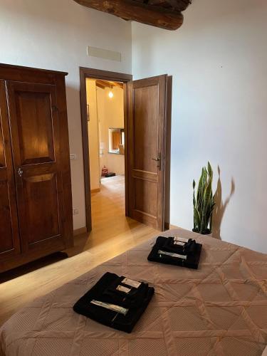 a bedroom with a bed with two towels on it at Civita Home Belvedere in Civita di Bagnoregio