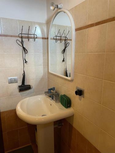 a bathroom with a sink and a mirror at Civita Home Belvedere in Civita di Bagnoregio