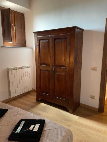 a room with a large wooden cabinet in a room at Civita Home Belvedere in Civita di Bagnoregio