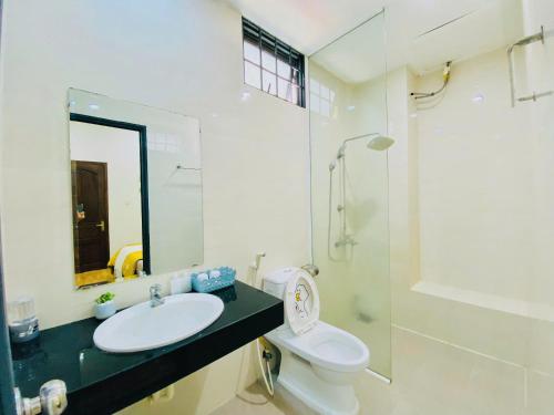 a bathroom with a sink and a toilet and a shower at Pina Home in Da Nang