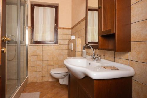 a bathroom with a sink and a toilet and a shower at NEW!!! La Magrina - Bed&Breakfast in Vrsar