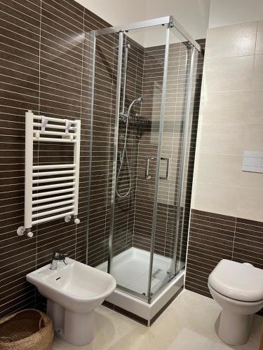 a bathroom with a shower and a toilet and a sink at Daniela Luxury Apartment in Rome