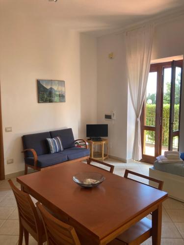 a living room with a table and a couch at Il Casalino in Maratea