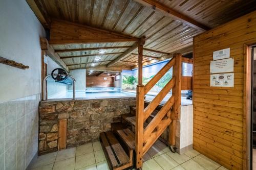 a room with a wooden staircase in a house at La Flèche d'Or in Châtel