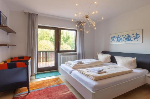 a bedroom with two beds and a chandelier at Landgasthaus Backhof-Helmle in Breitnau