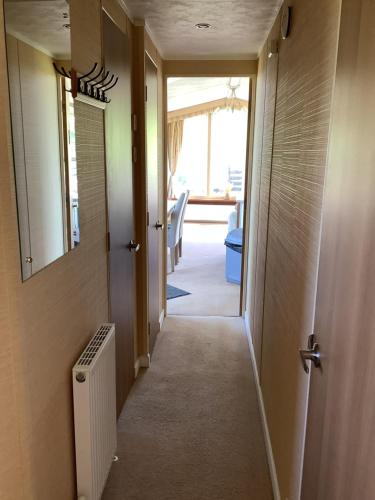 a hallway leading to a room with a hallway at Meadowview in Cardigan