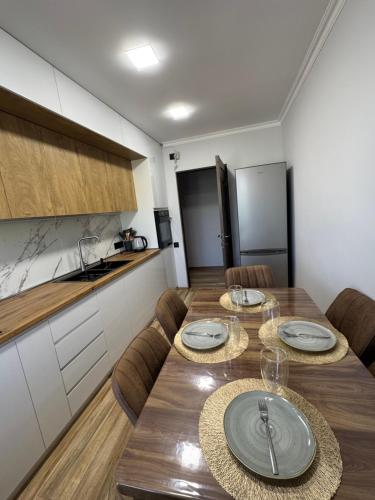 a dining room with a table and a kitchen at Armani in Yeghegnadzor