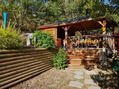 a small cabin with a stairs leading to it at Gîte La Magnanerie in Reilhanette
