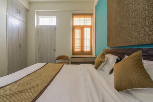 Ένα ή περισσότερα κρεβάτια σε δωμάτιο στο The Hotel Madhavam