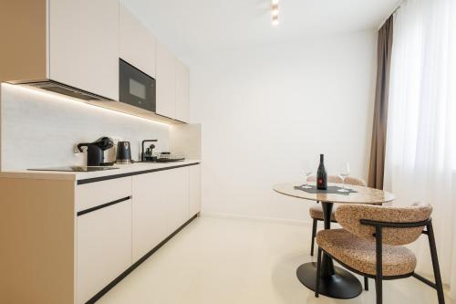 a white kitchen with a table and a counter at Apartments Maritea in Vodice