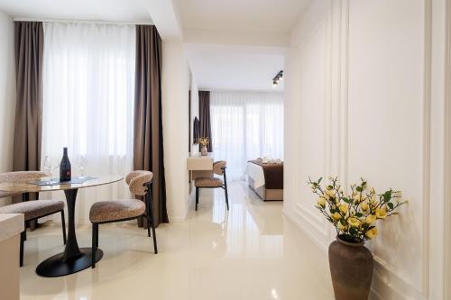 a living room with a table and chairs and a bedroom at Apartments Maritea in Vodice