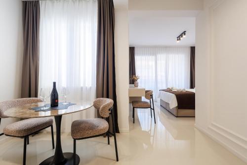 a room with a table and chairs and a bed at Apartments Maritea in Vodice