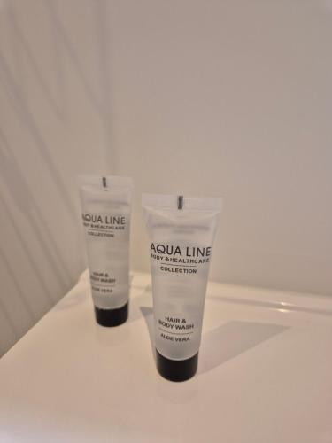 two bottles of extra line moisturizers sitting on a table at Huis ALNA 6 in Mechelen