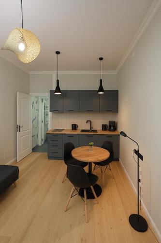 a kitchen with a table and chairs in a room at Poti Seaside Apartment in Poti