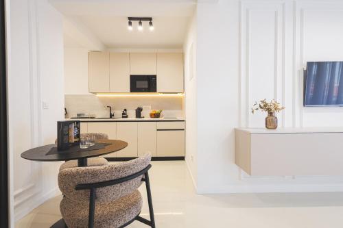 a kitchen with a table and chairs in a room at Apartments Maritea in Vodice