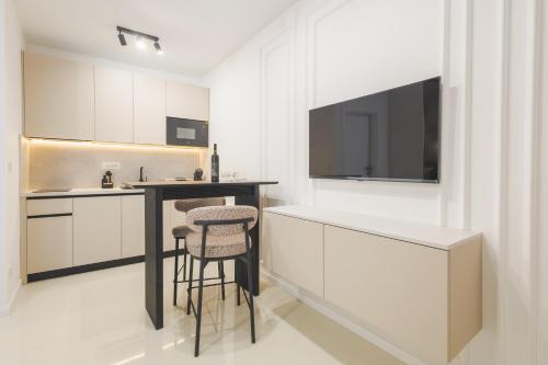 a kitchen with a counter and a bar with stools at Apartments Maritea in Vodice