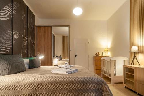 a bedroom with a large bed and a mirror at STING Boutique Apartments in Ostrava