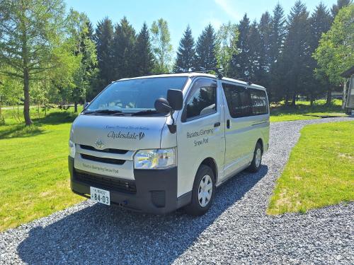 a white van parked on a gravel road at Rusutsu Pension Clydesdale in Rusutsu
