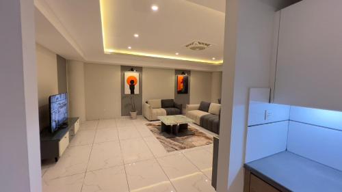 a living room with a couch and a tv at 1 BHK Sleek Suite Apt in Bahria Heights 1 in Rawalpindi