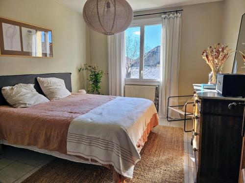 une chambre avec un grand lit et une fenêtre dans l'établissement Jolie villa avec piscine proche du centre historique, à Arles