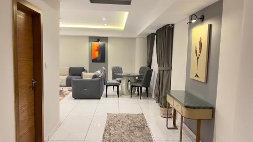 a living room with a table and chairs at 1 BHK Sleek Suite Apt in Bahria Heights 1 in Rawalpindi