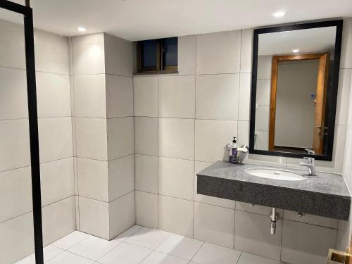 a bathroom with a sink and a mirror at 1 BHK Sleek Suite Apt in Bahria Heights 1 in Rawalpindi
