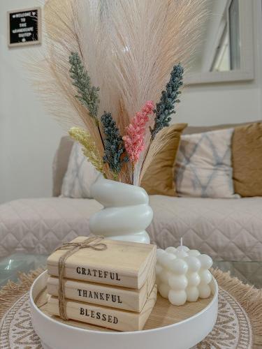 a table with a vase and books on a table at The Sandscape Suite in Manila