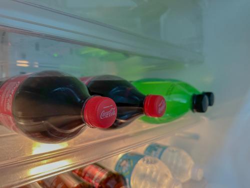 three bottles of wine are sitting in a refrigerator at The Sandscape Suite in Manila
