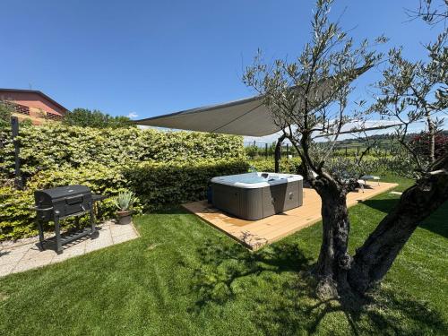 a hot tub sitting on a deck next to a tree at Nature Home Apartment in Sandra