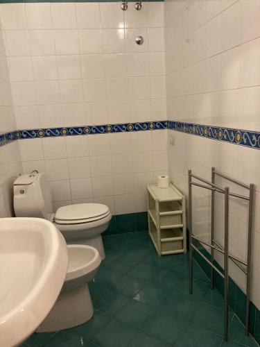 a bathroom with a toilet and a sink at Il Casalino in Maratea