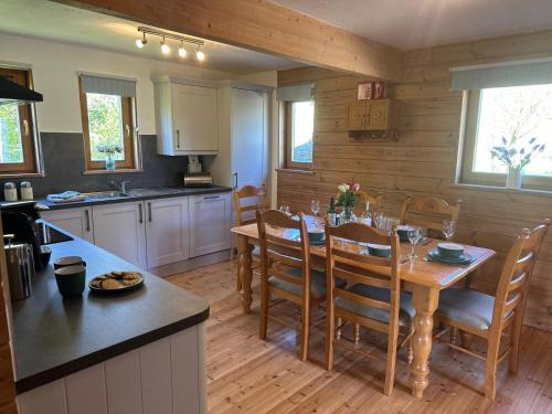 a kitchen and dining room with a table and chairs at The New Farmhouse in Biggar