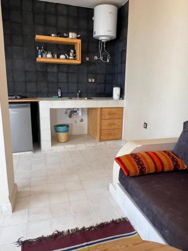 a kitchen with a sink and a counter in a room at SurfAppart Morocco in Tamraght Ouzdar