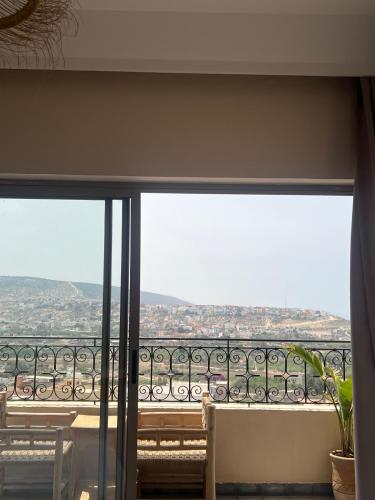 a balcony with a view of a city at SurfAppart Morocco in Tamraght Ouzdar