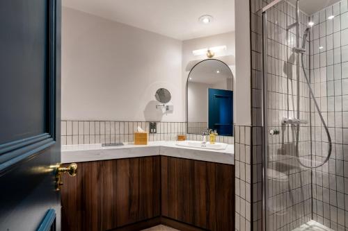 a bathroom with a sink and a shower at The Chamberlain in London