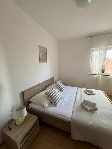 Postel nebo postele na pokoji v ubytování Apartmani "Bodulo"