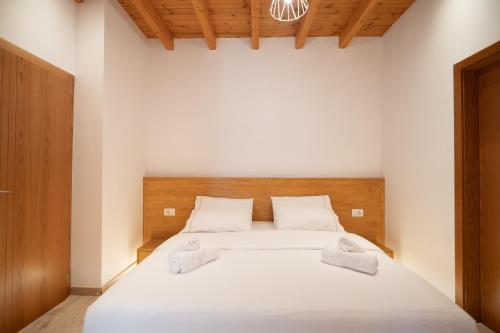 a bedroom with a bed with two towels on it at Bujtina Harusha in Theth