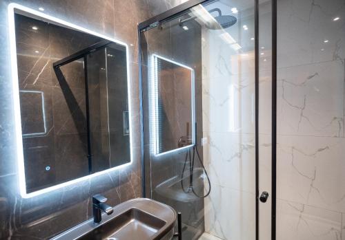 a bathroom with a shower and a sink at Bujtina Harusha in Theth