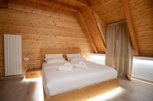 a bedroom with a bed with two towels on it at Bujtina Harusha in Theth