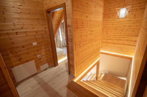 a cabin with wooden walls and wooden flooring at Bujtina Harusha in Theth