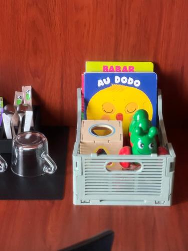 a toy toy box filled with toys on a table at Hôtel Marguerite in Paris