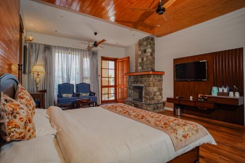 a bedroom with a large bed and a fireplace at Neelesh Inn- A Luxury Lake View Hotel- 20 kms from Nainital in Bhīm Tāl
