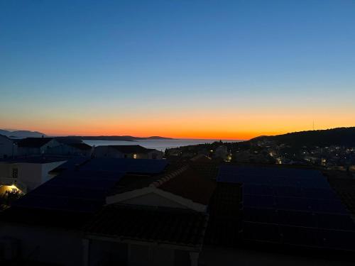 a view of the sunset from the roofs of buildings at Loft with Sea and Fortress View Central Hvar in Hvar